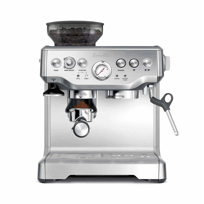 Breville coffee machine in silver with coffee beans and portafilter
