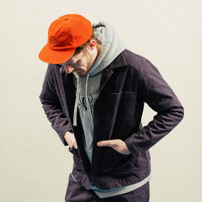 Roasters jacket in blue on model wearing hoodie and cap